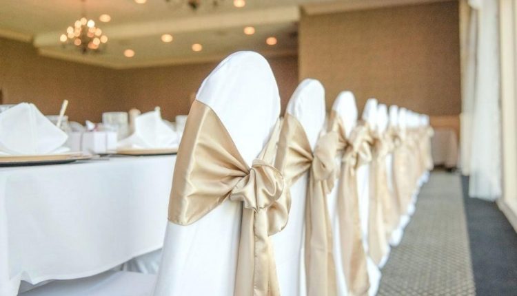 gold-and-white-spandex-chair-covers-with-sash-bows-wedding-day-decor-head-table-kitchen-agreeable-dec-1043×696